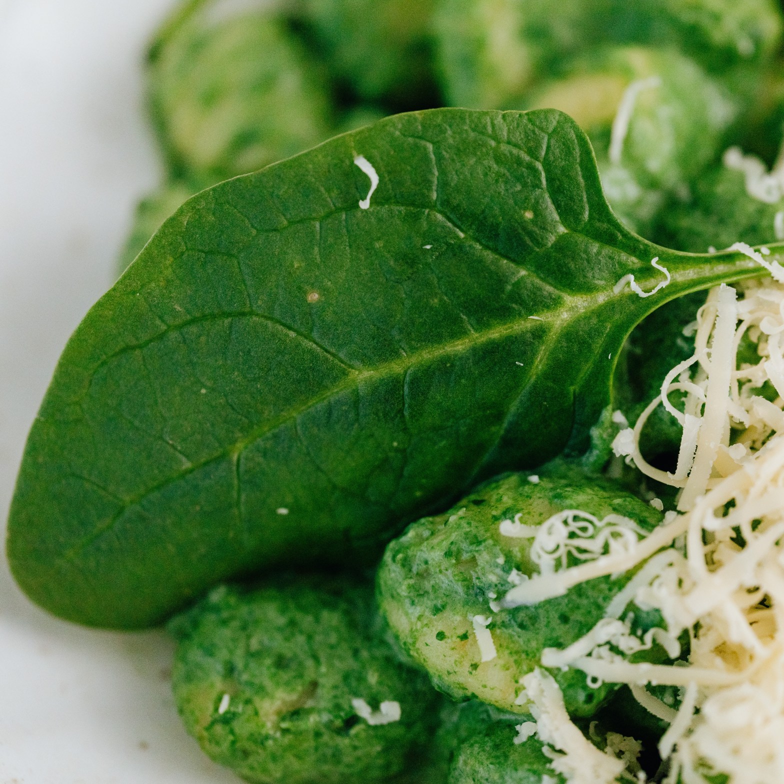gnocchi with spinach leaves and parmesan cheese